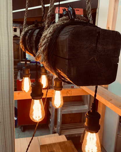 Custom made light fixture on 100-year-old barn wood from Quebec